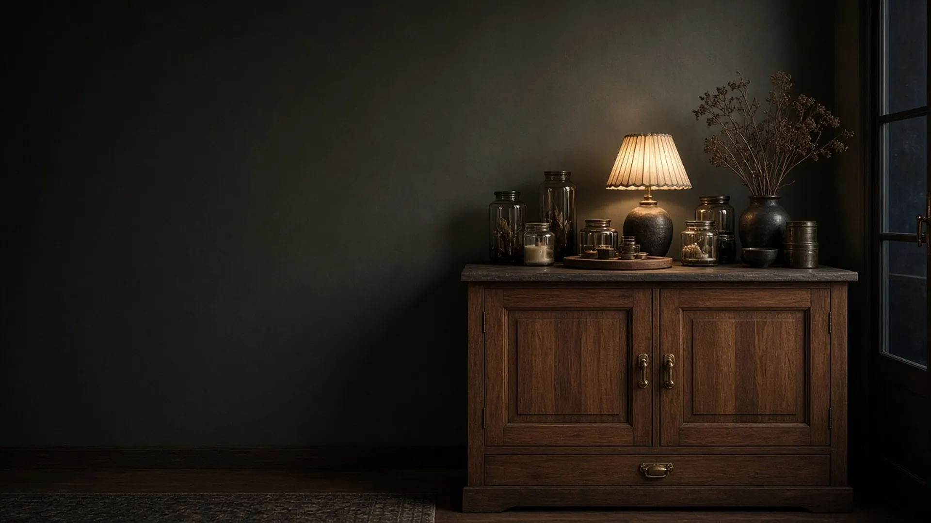 A closed wooden cabinet with brass pulls in a candle workshop